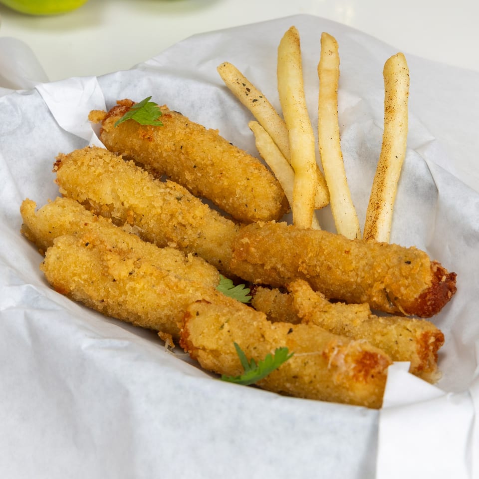 Fried mozzarella sticks and french fries in a white paper-lined basket at Halal Kitchen Cafe.
